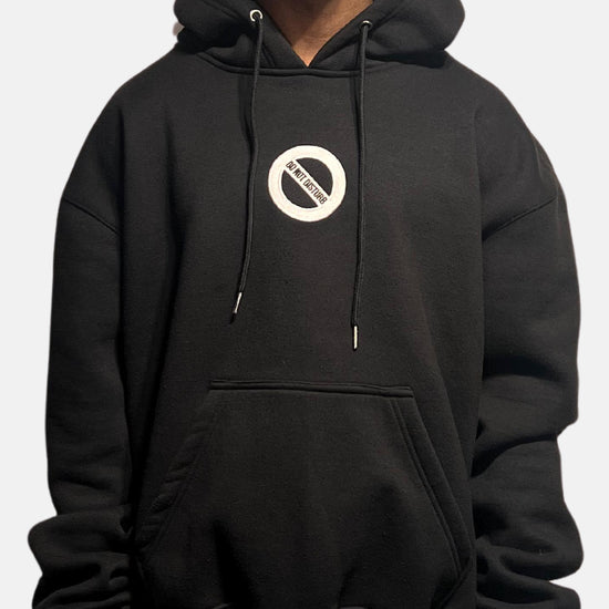 Video showing black oversized hoodie being worn in different environments